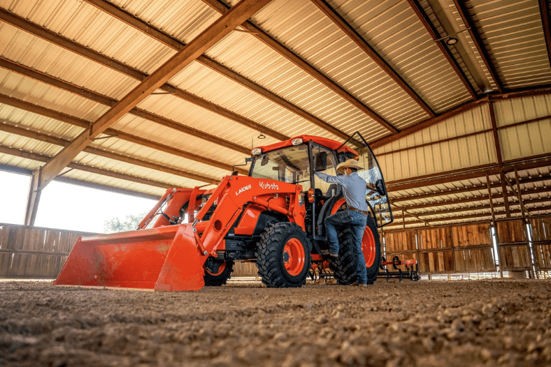 Man stepping into cab of tractor