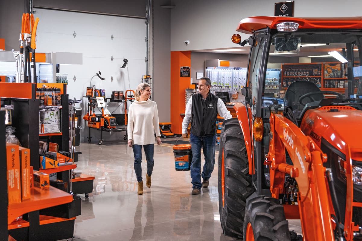 Staff member and customer in Kubota dealership lobby