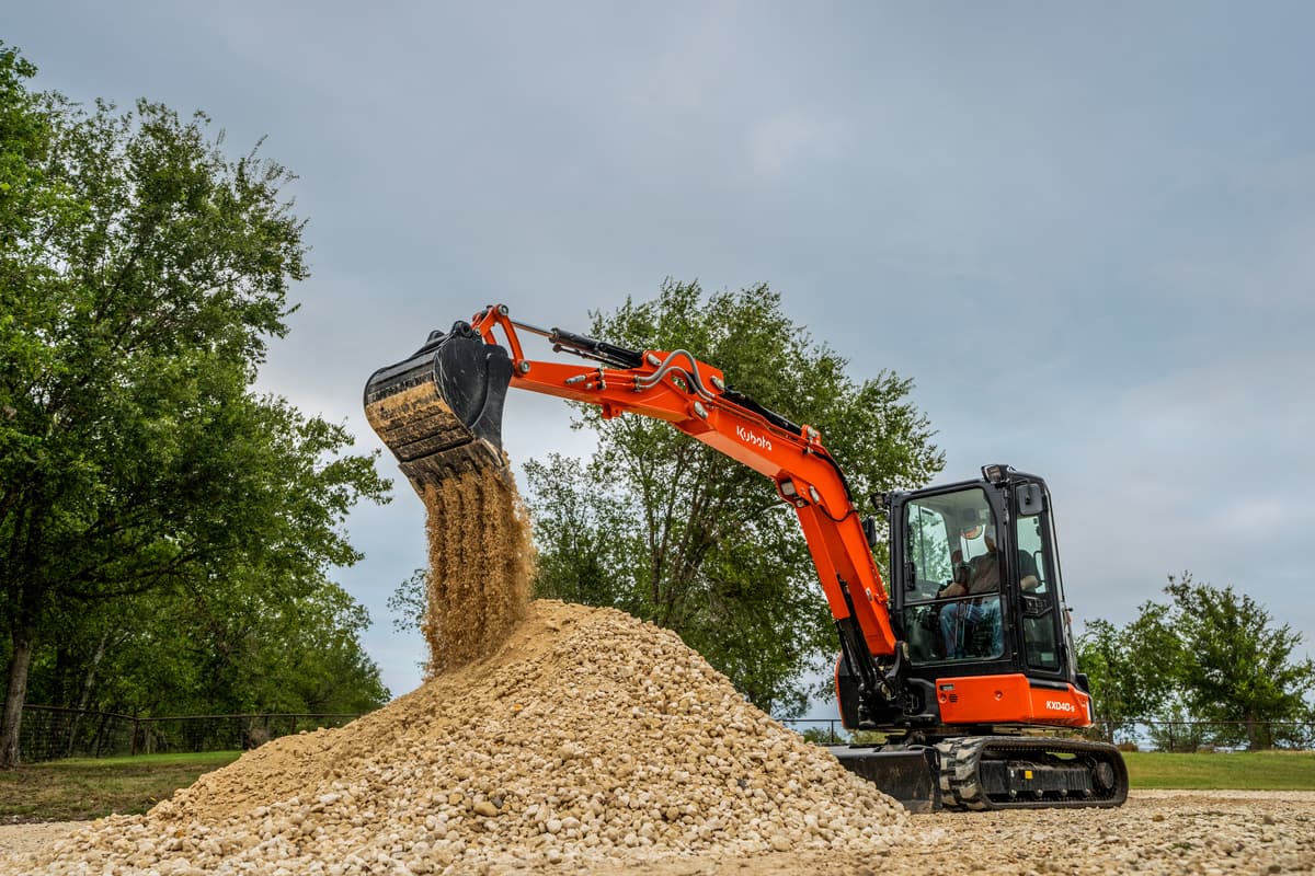 Kubota Compact Excavator scooping dirt
